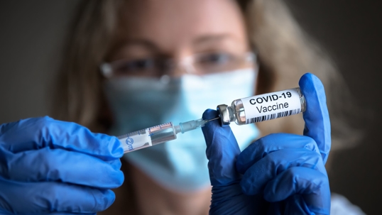 nurse with covid-19 vaccine